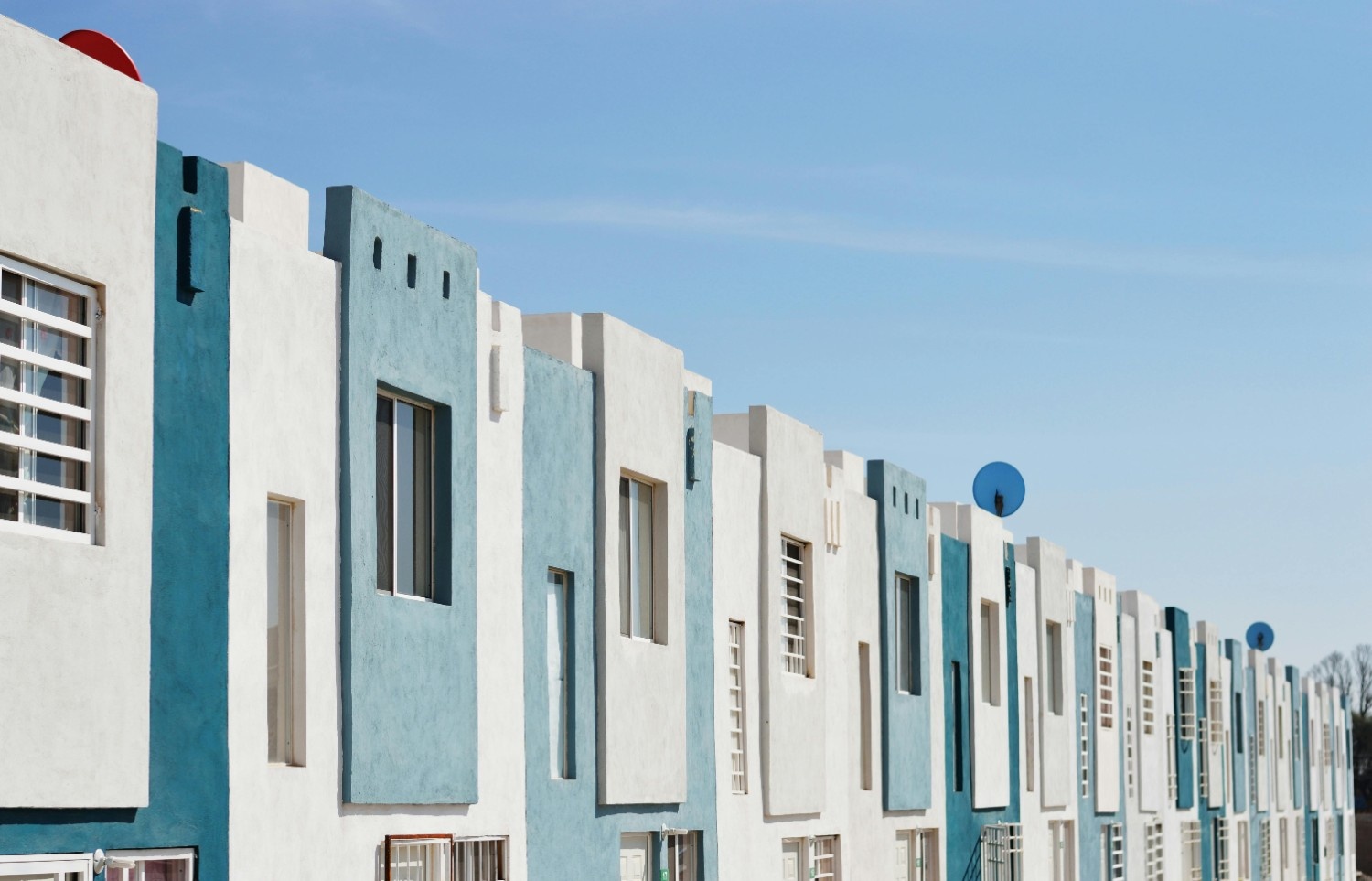 Row of planned residential homes, representing large-scale community management across a coordinated housing development.