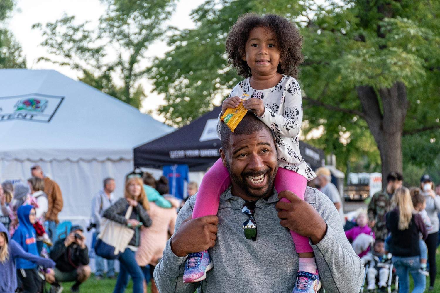 Parent and child attending a neighborhood community event in Austin.