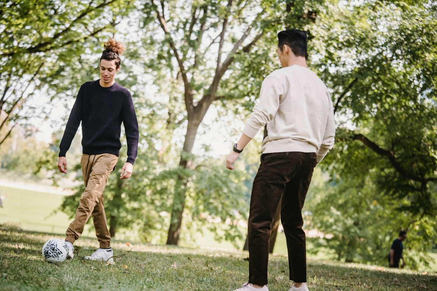 Residents enjoying outdoor recreation in a shaded Houston community park.