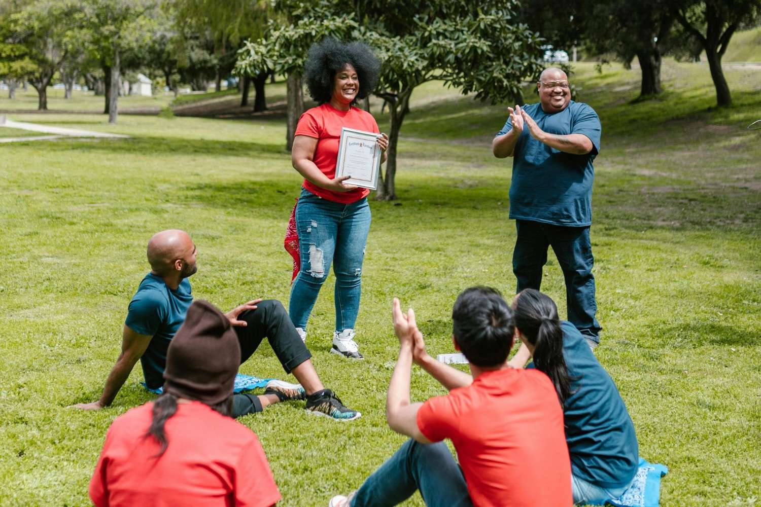 Community members recognizing a resident during an outdoor event in Dallas-Fort Worth.