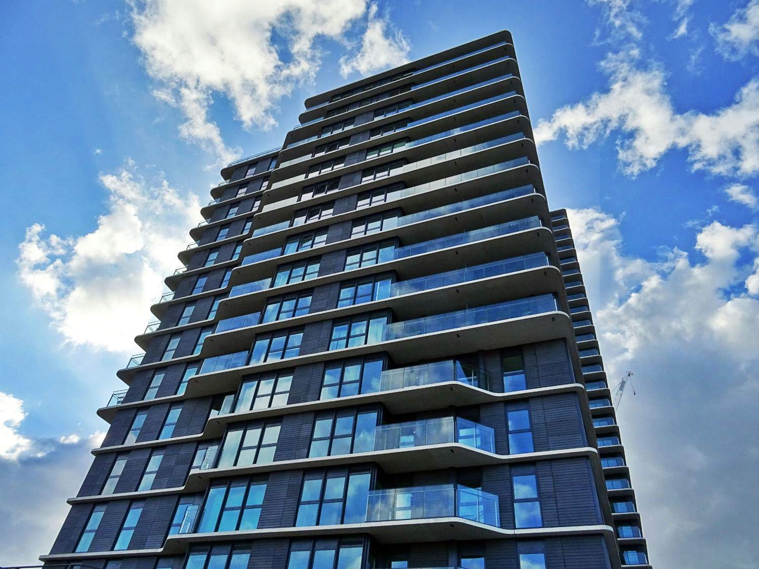 Modern high-rise condominium building with balconies, representing professional condominium association management services in San Antonio, Texas.