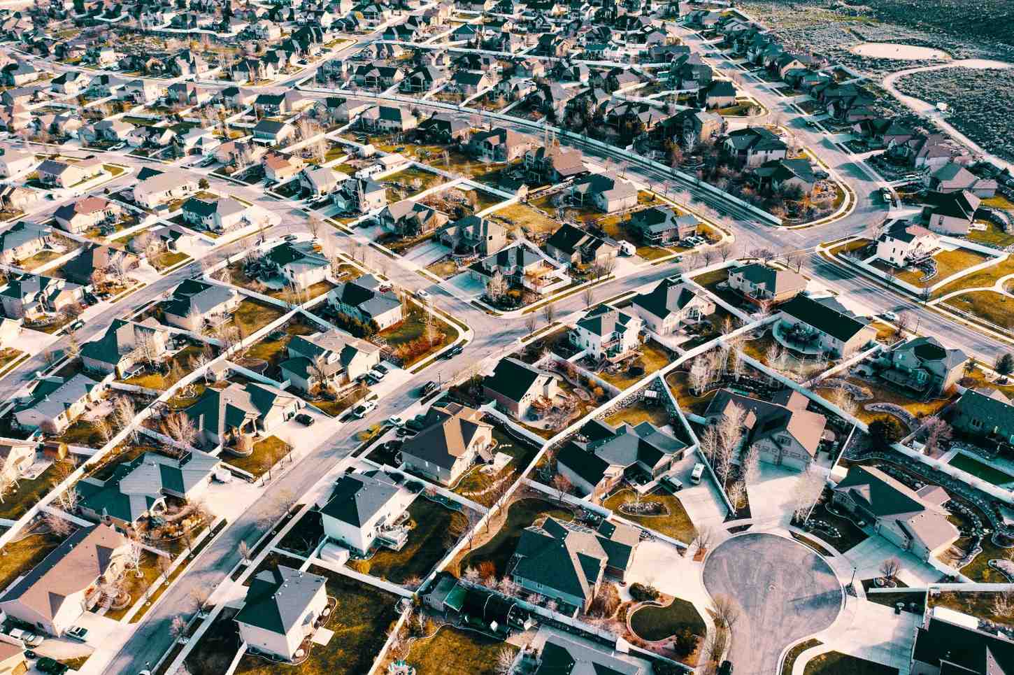 Aerial view of a large residential neighborhood with single-family homes, streets, and community infrastructure, representing HOA and community association management services in San Antonio, Texas.