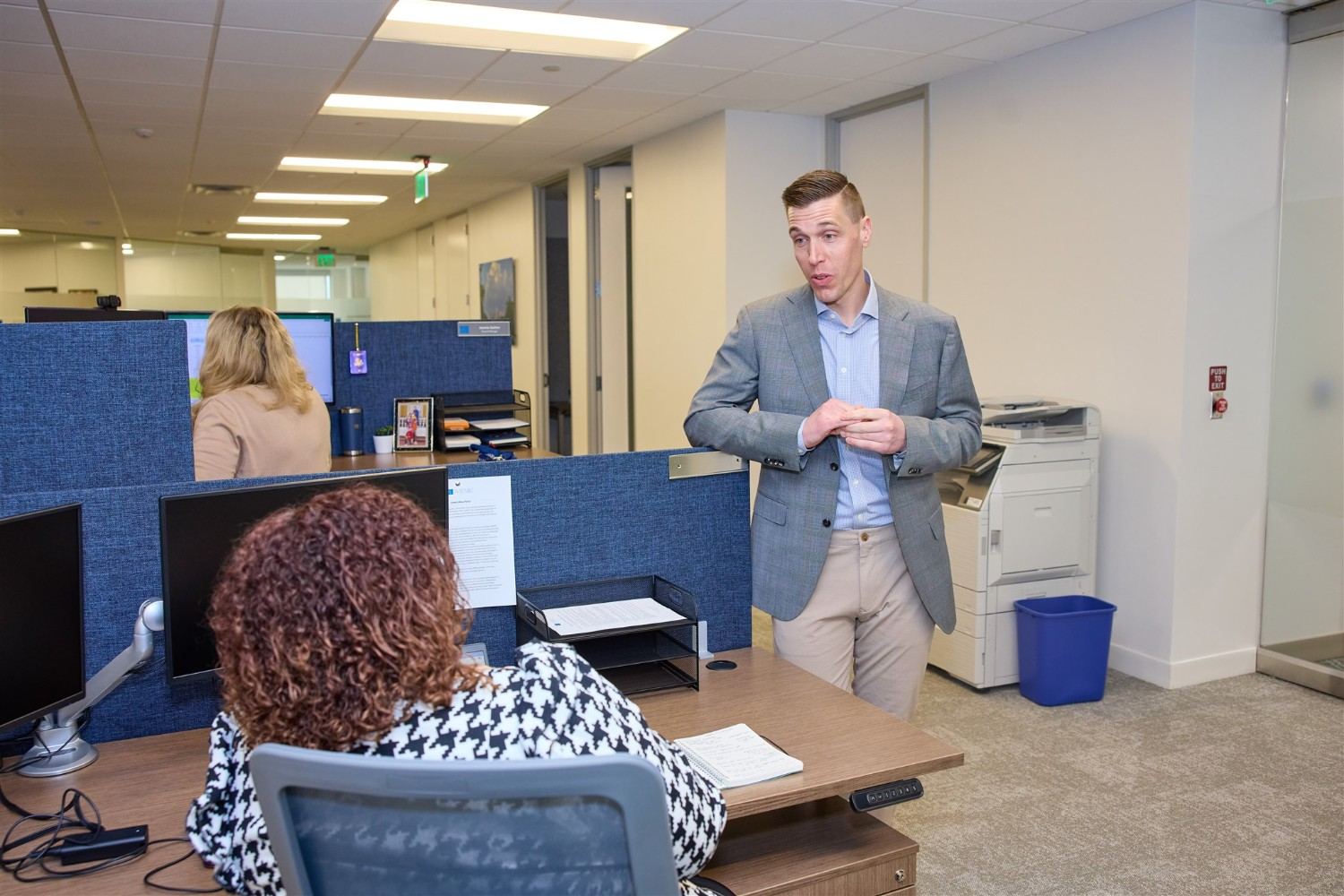 WRMC Texas HOA management team assisting residents in a professional Frisco office.