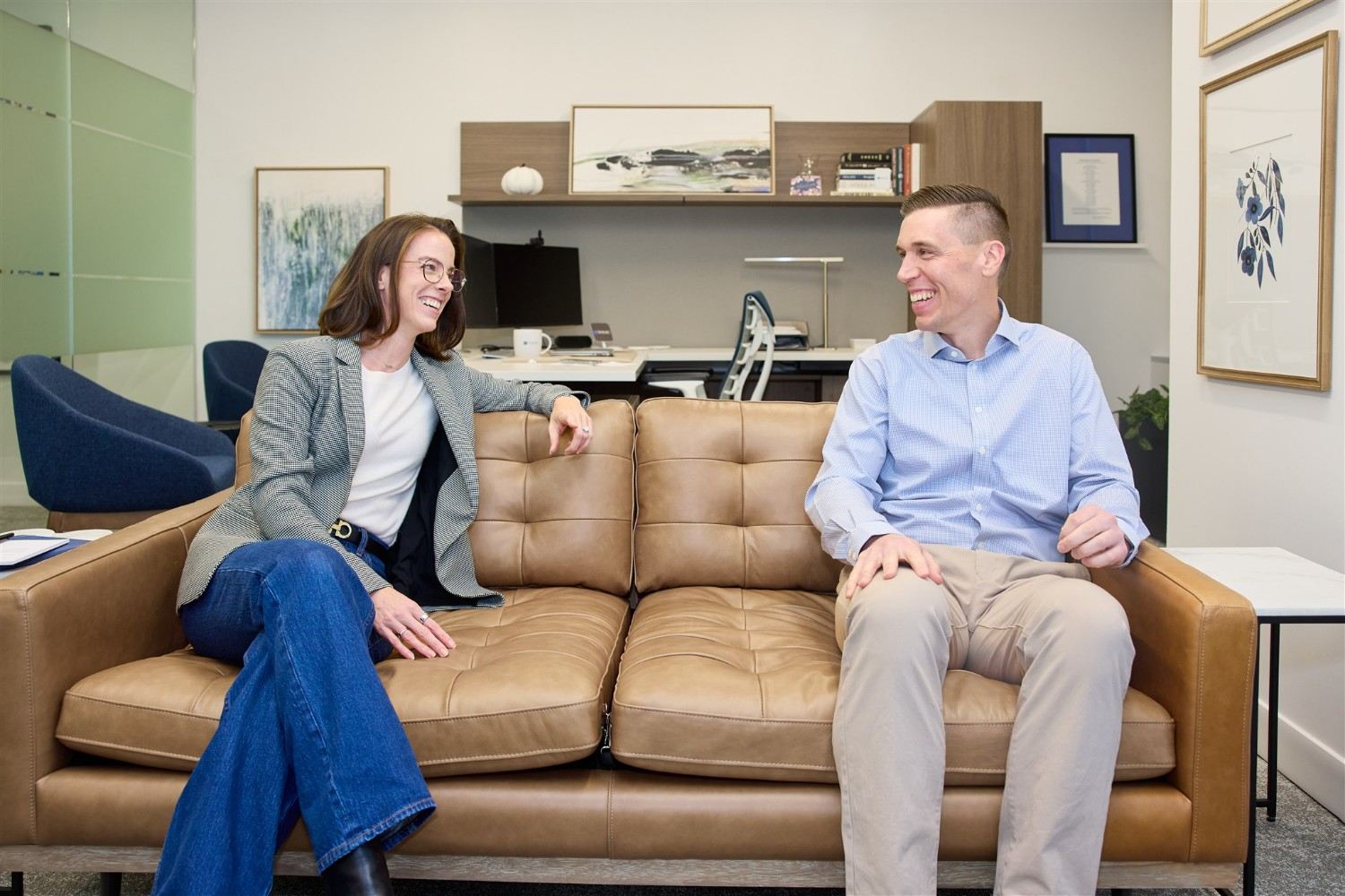HOA management professionals discussing community services in an office.